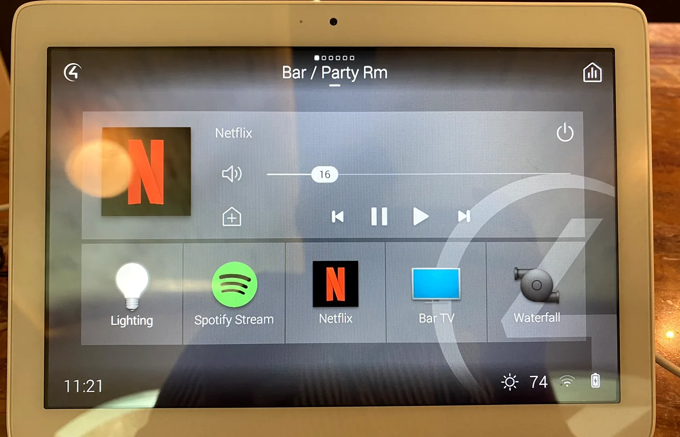 Bar and party room on an in-wall touchscreen — lighting, streaming and the waterfall