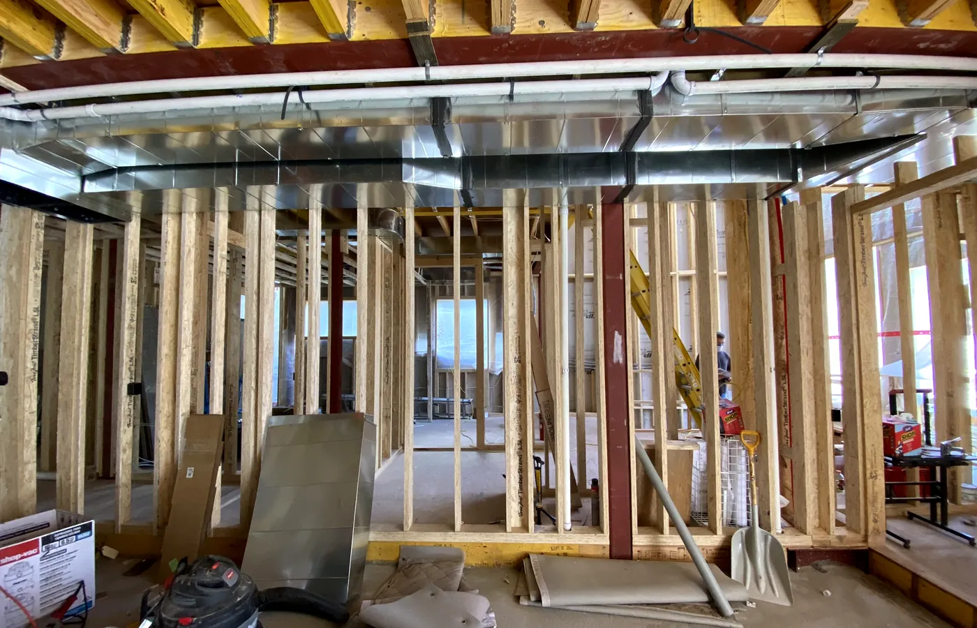 Steel, joists and ductwork in — device positions agreed before anything closes