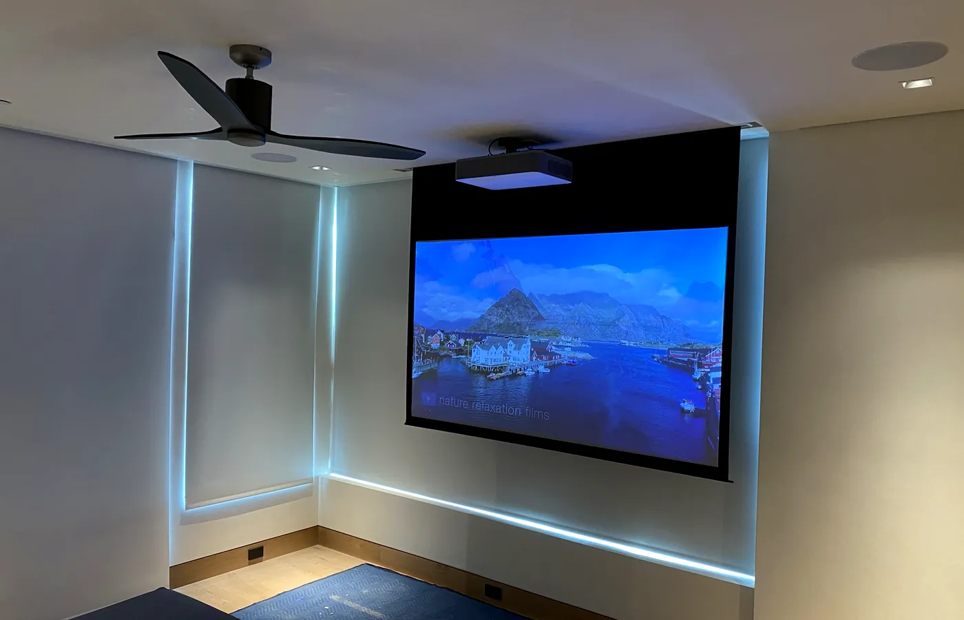 The media room — projector, motorized screen and concealed cove lighting